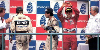 1989. Canada. Andrea De Cesaris on the podium with Thierry Boutsen and Riccardo Patrese.